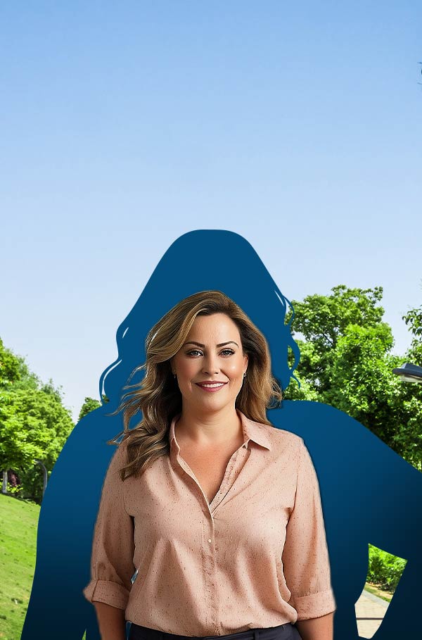 A woman standing in front of a large blue and green sign in Perth promoting weight loss surgery.